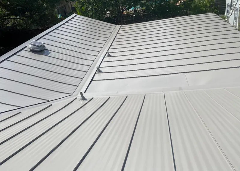 Solar attic fan installed on a metal roof for Roof Ventilation in Eden Isle